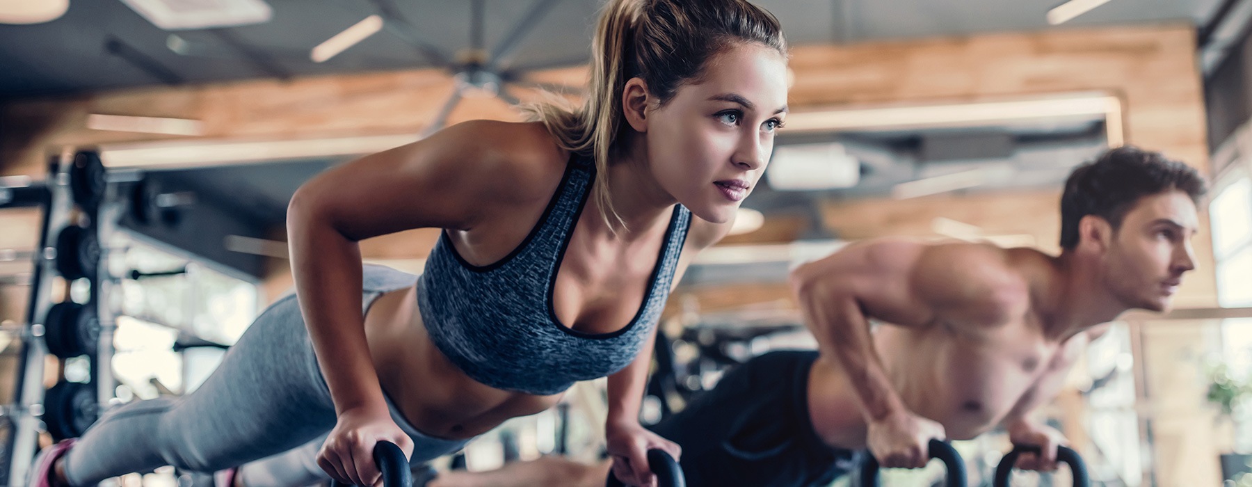 lifestyle image of two people working out in a fitness center